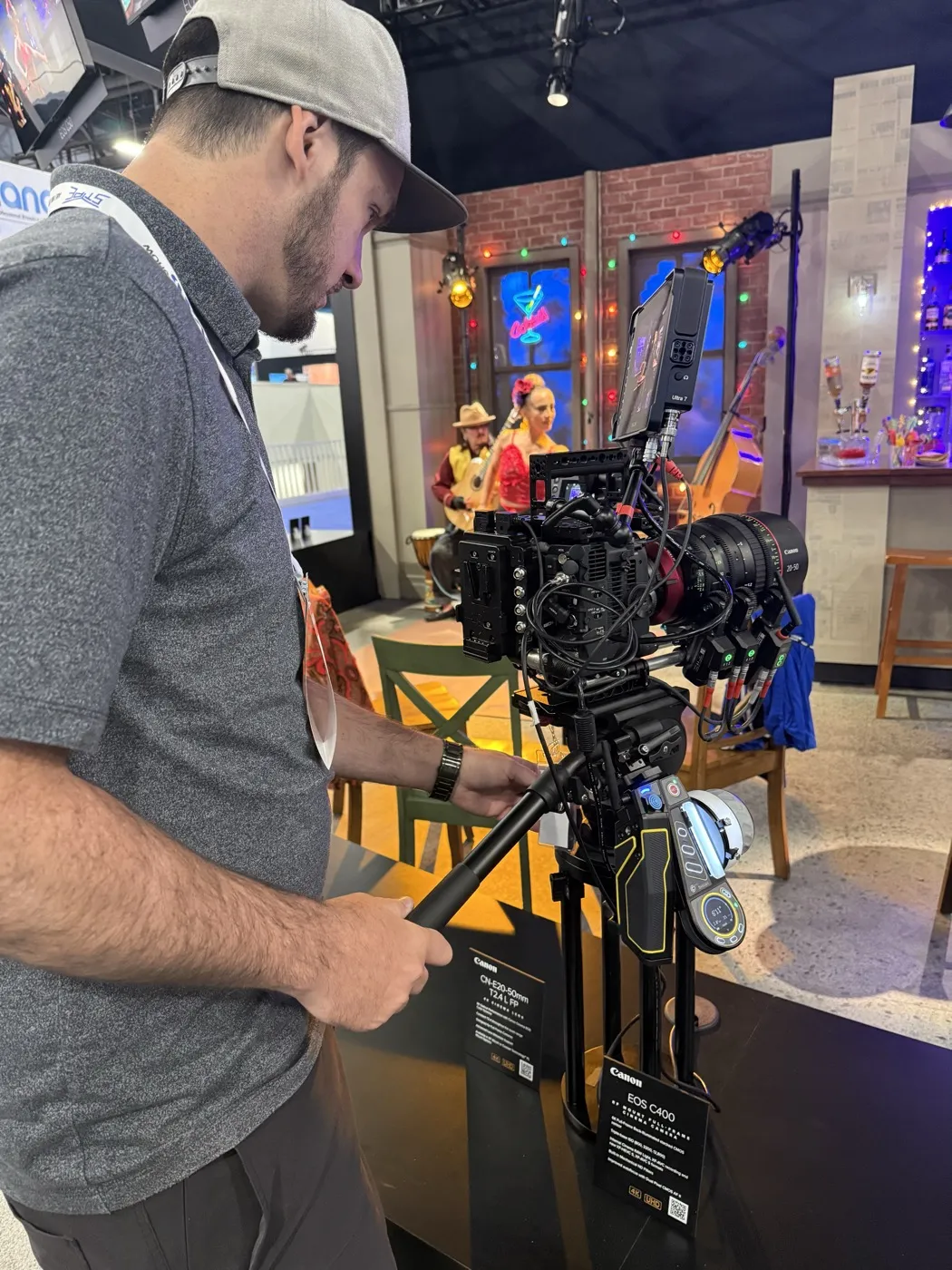 Ryan operating a Canon cinema camera on a tripod at an indoor set